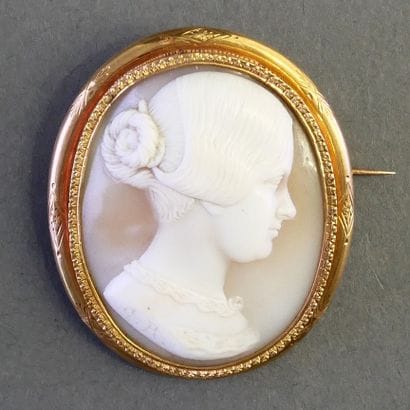 CAMEA COQUILLE PIERCE adorned with a woman's...