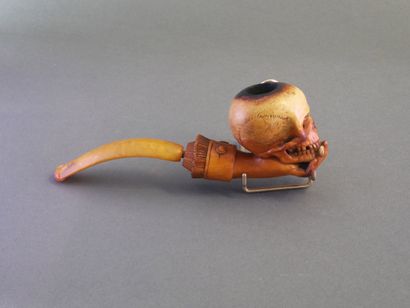 Carved meerschaum pipe depicting a hand holding...