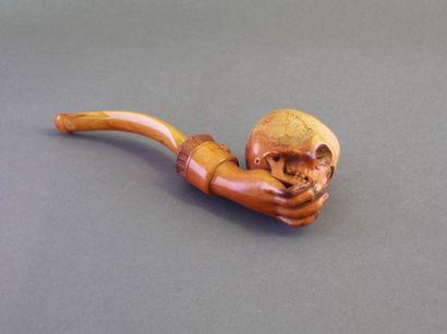 Carved meerschaum pipe depicting a hand holding...