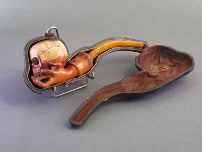 Carved meerschaum pipe depicting a hand holding...