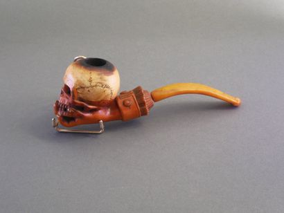 Carved meerschaum pipe depicting a hand holding...