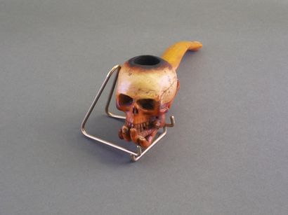 Carved meerschaum pipe depicting a hand holding...
