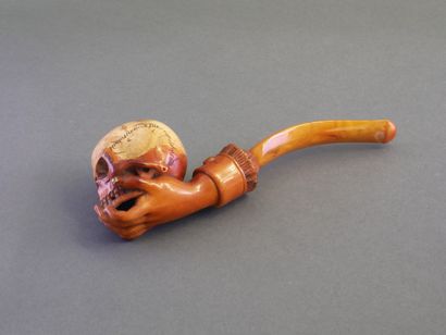 Carved meerschaum pipe depicting a hand holding...