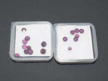 Set of 2 boxes of round-cut rhodolite garnets...