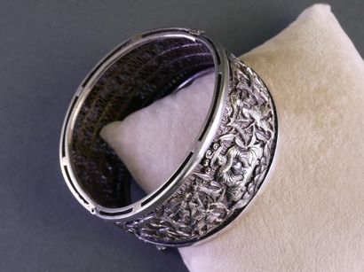 A rigid, clasp-style silver bracelet (min....
