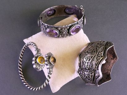 Set of three rigid, clasp-style silver bracelets...