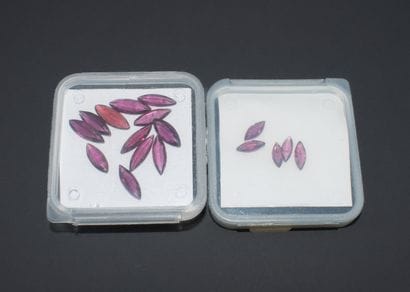 Set of 2 boxes of shuttle-cut rhodolite garnets.
Total...