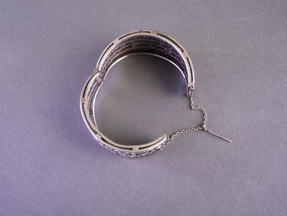 A rigid, clasp-style silver bracelet (min....