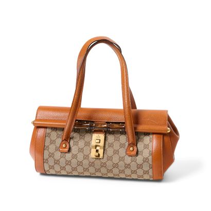 GUCCI BAG
In G canvas, gold leather and patent...