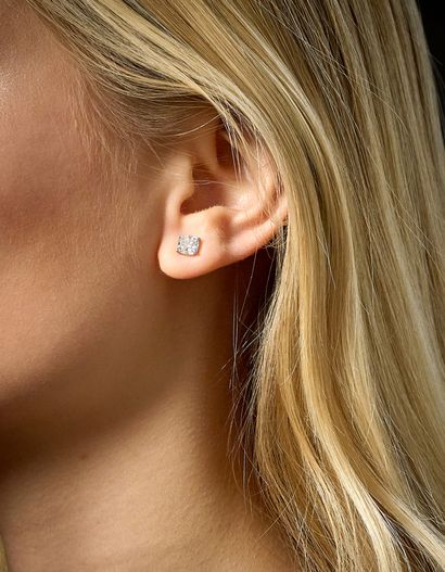 PAIR OF EARRINGS
each adorned with a cushion-cut...
