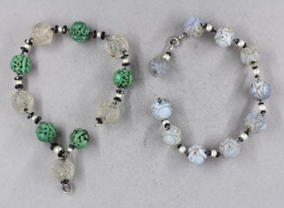 Two engraved hard stone ball bracelets, ...