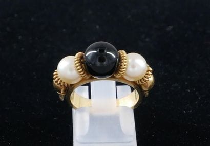 *Yellow gold ring set with two cultured pearls...