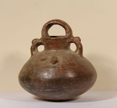 Globular vase decorated with two faces

Vicus...