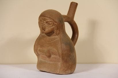 Stirrup vase representing a character wearing...