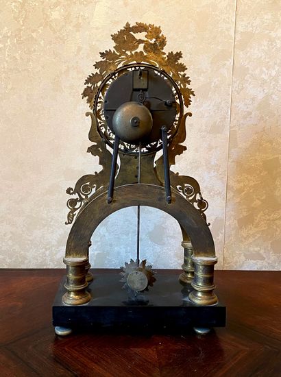 *Pendule squelette en bronze, fronton ornée...