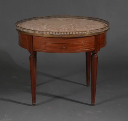 Low round pedestal table in stained wood...