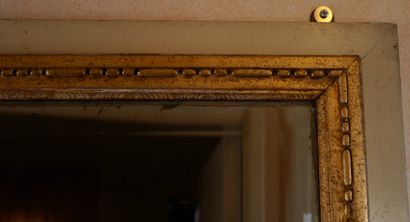 Rectangular glass in carved wood, stuccoed,...