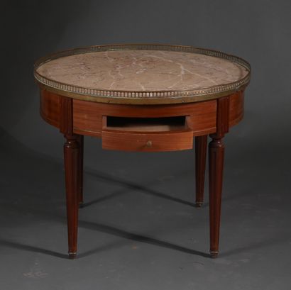 Low round pedestal table in stained wood...