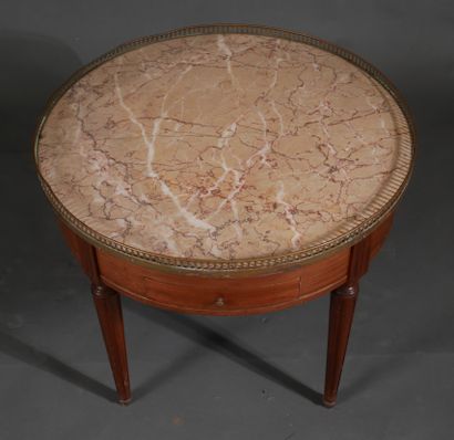 Low round pedestal table in stained wood...