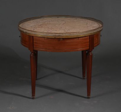 Low round pedestal table in stained wood...