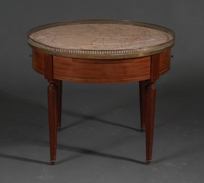 Low round pedestal table in stained wood...