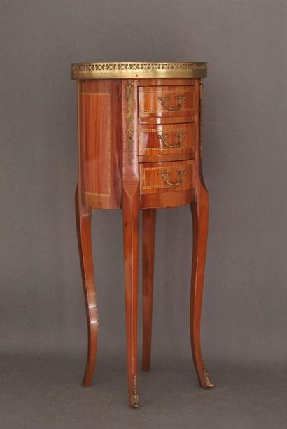 Oval veneered coffee table opening to three...