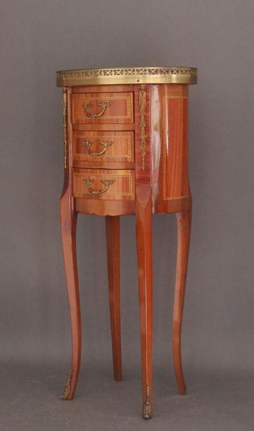 Oval veneered coffee table opening to three...