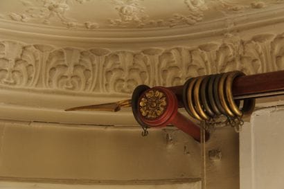 Wooden and bronze curtain rod and brackets,...