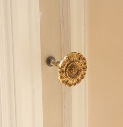 Wooden and bronze curtain rod and brackets,...