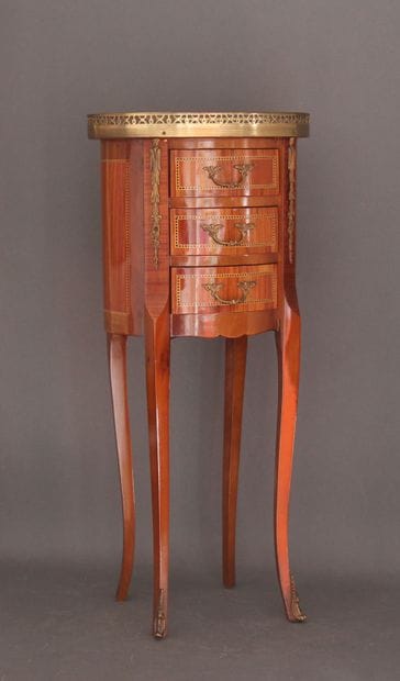 Oval veneered coffee table opening to three...