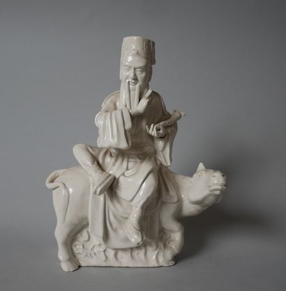 White porcelain statuette of an old man sitting...