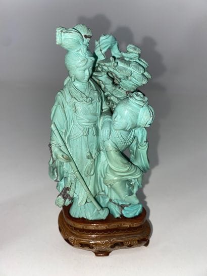 CHINA Set of three turquoise statuettes representing...