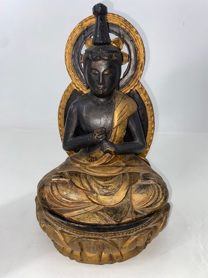 Carved and gilded black lacquered wood Buddha,...