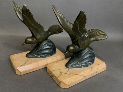 Pair of bookends in patinated metal on a...