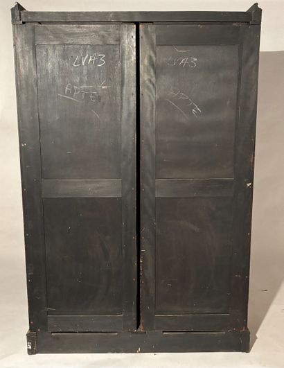 Two-door cabinet in blackened and gilded...