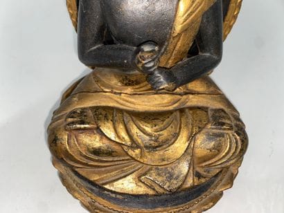 Carved and gilded black lacquered wood Buddha,...
