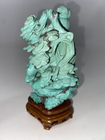 CHINA Set of three turquoise statuettes representing...