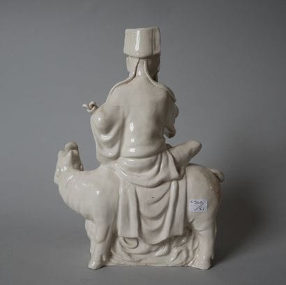 White porcelain statuette of an old man sitting...