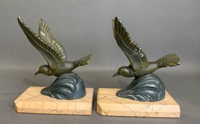 Pair of bookends in patinated metal on a...