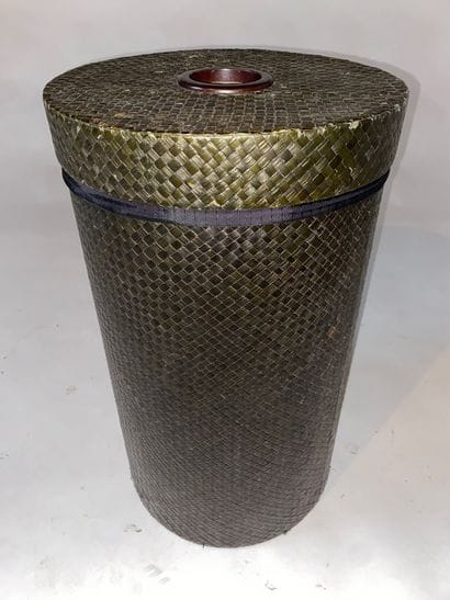 Cylindrical, woven and stained laundry basket....