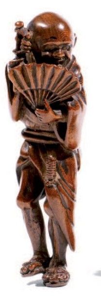 Netsuke en bois représentant un sennin tenant...