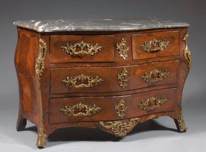 Commode tombeau de forme chantournée en placage...