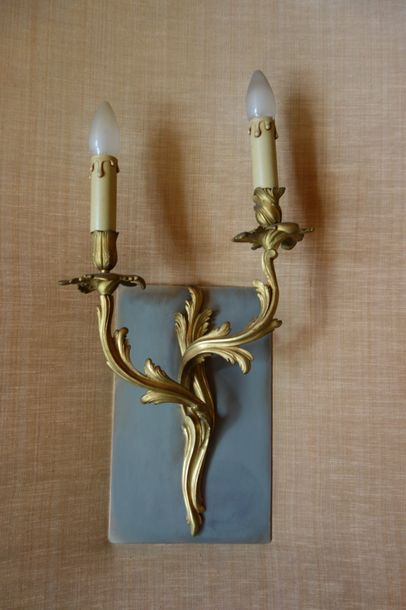 Trois appliques en bronze doré à deux lumières,...