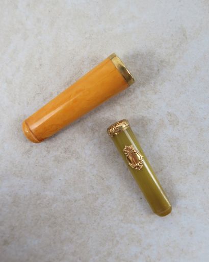 Deux fume-cigarettes en bakélite et or 18K...