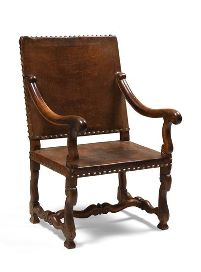 Fauteuil en noyer et cuir clouté, le dossier...