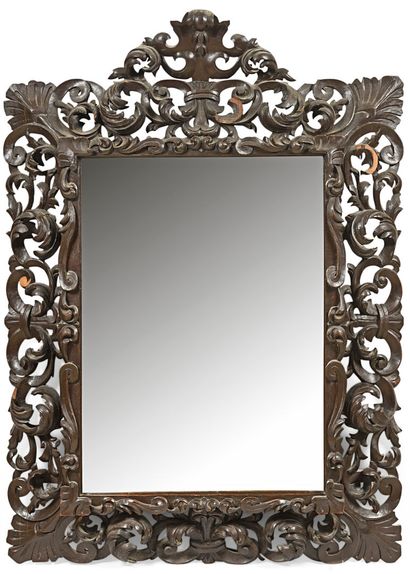 Important mirror in molded and carved wood...