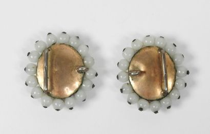 Two oval ornamental elements in silver or...