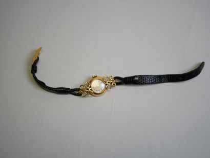 Ladies' gold watch on black bracelet.
C 14.79...
