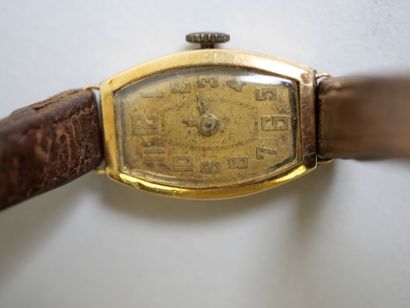 Ladies' gold watch on brown bracelet.
C 9.44...