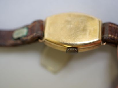 Ladies' gold watch on brown bracelet.
C 9.44...